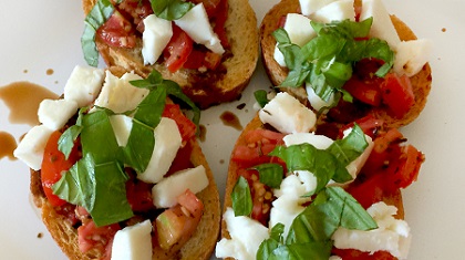 Toast layered with fresh mozzarella and tomato.
