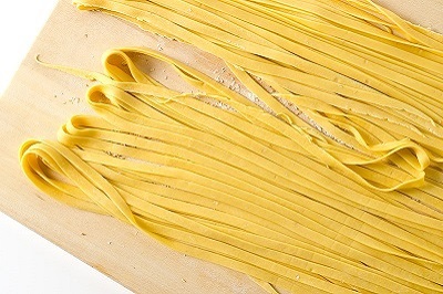 Pasta dough cut into fettuccine shape, ready to cook.