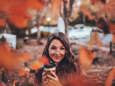 girl framed by leaves