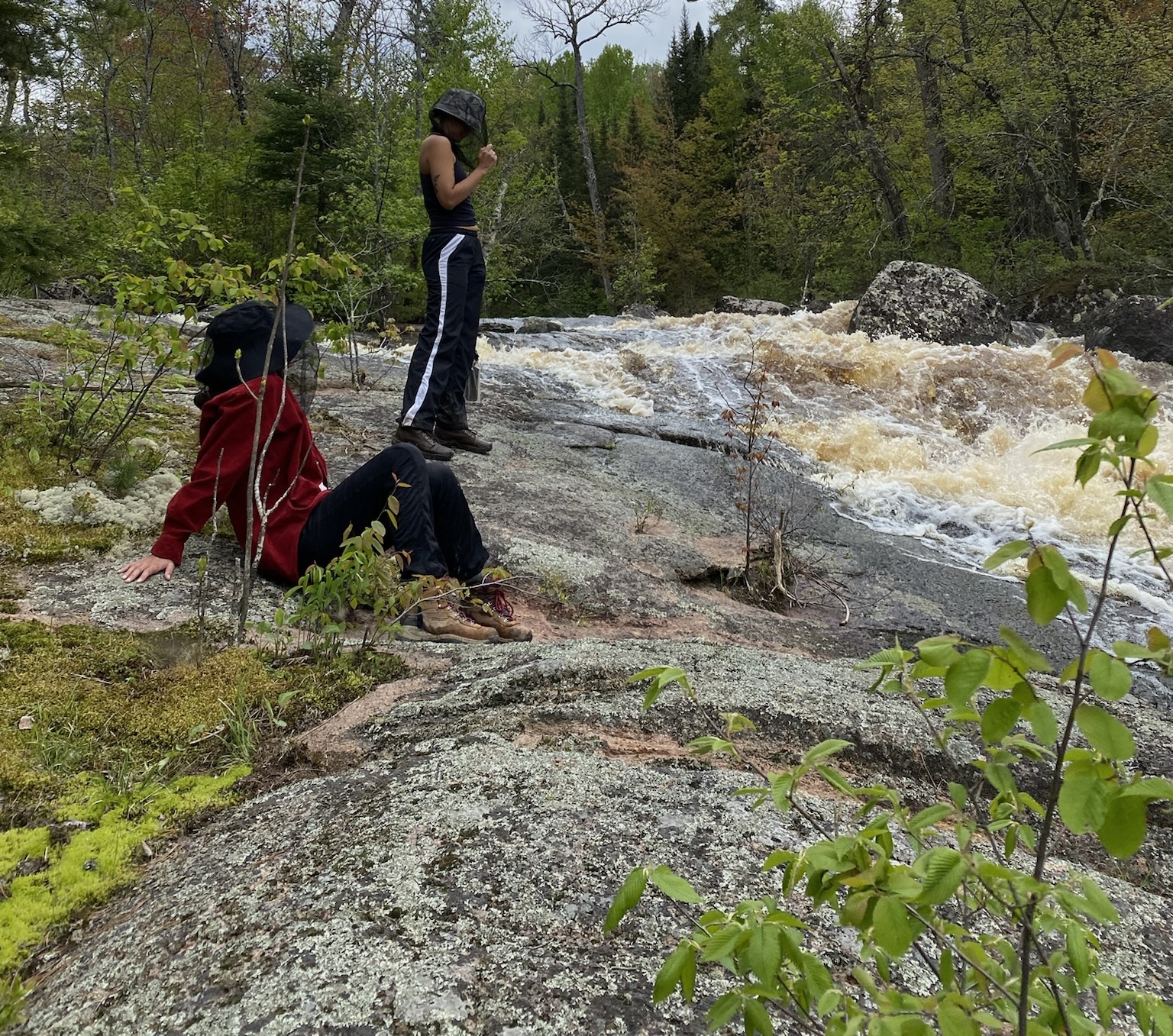 People sitting overlooking lake