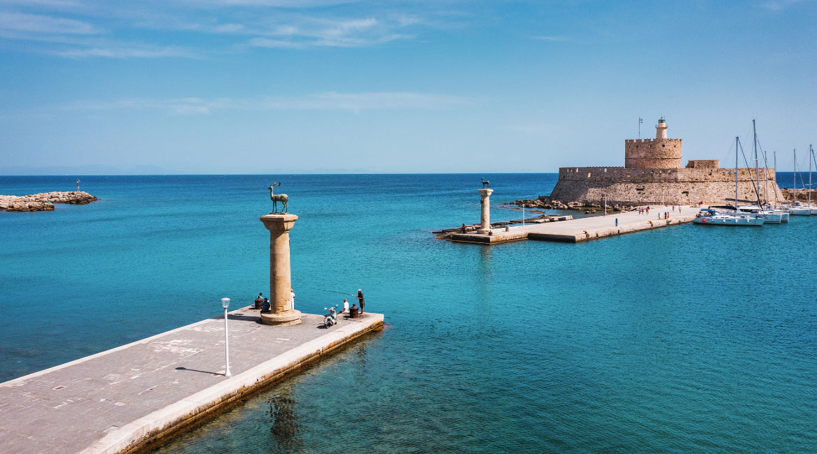 Rhodes harbor with boats and medieval buildings